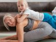 A senior woman and her young grandchild bonding during a fun yoga session indoors.